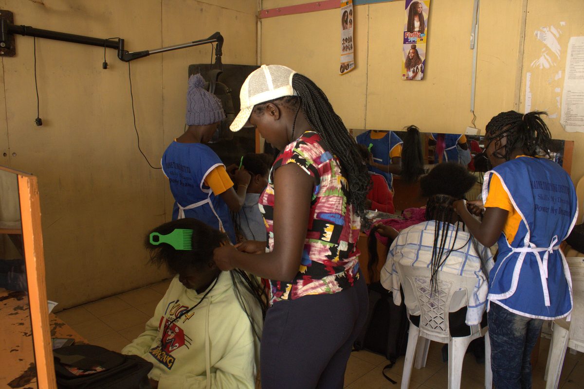 Cosmetology trainees practising hairdressing at Germaine