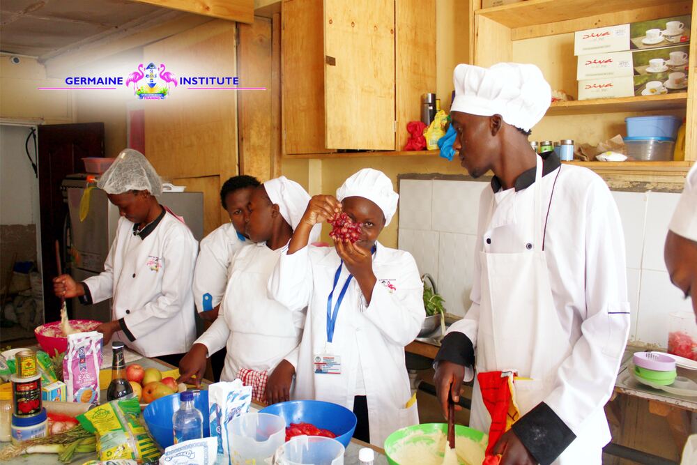 Catering trainees preparing food in the Germaine kitchen