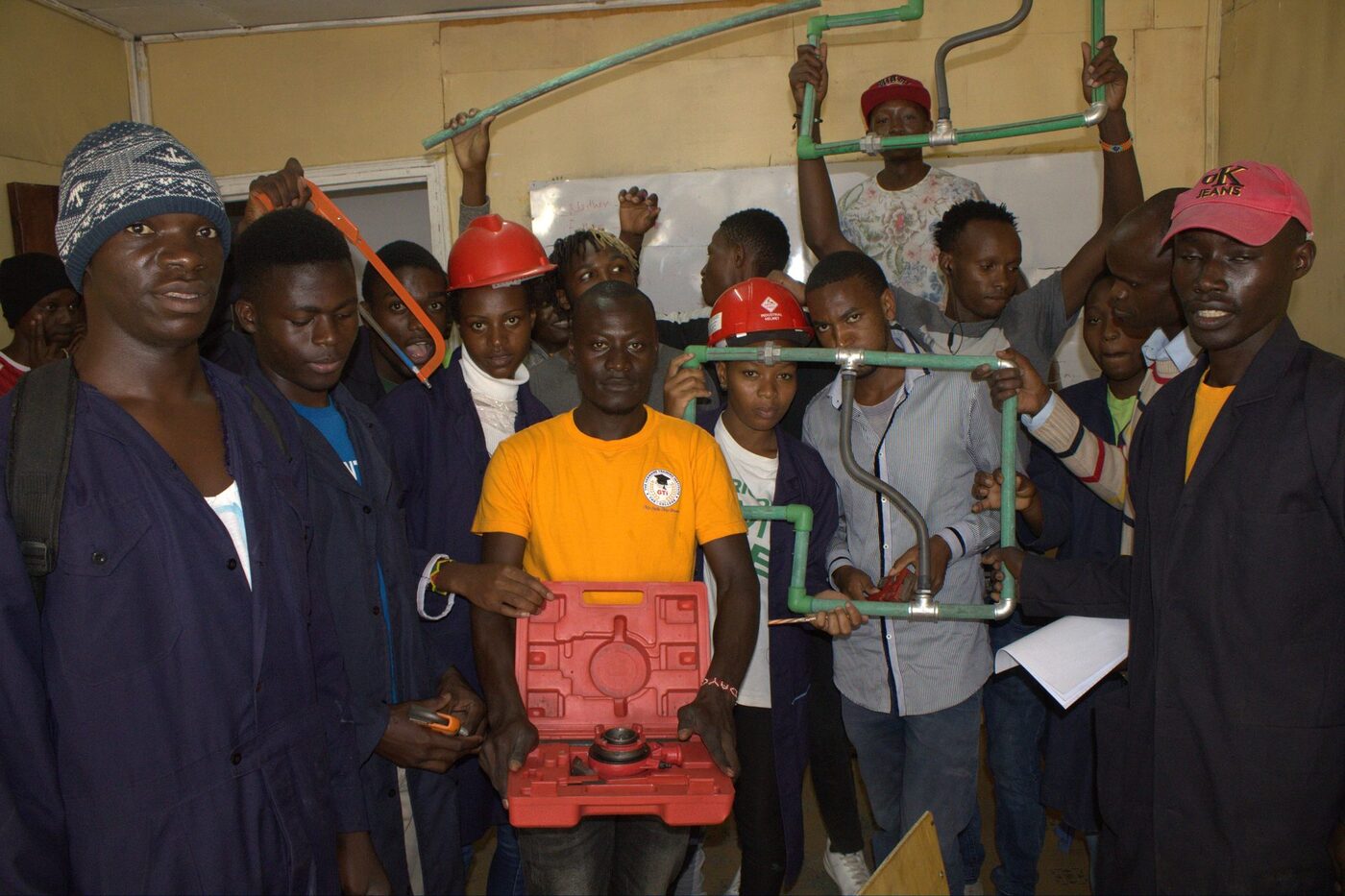 Engineering trainees working together on a plumbing project