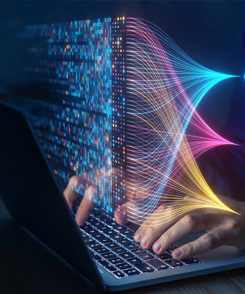 Hands typing on a laptop with a data analytics visualisation overlay