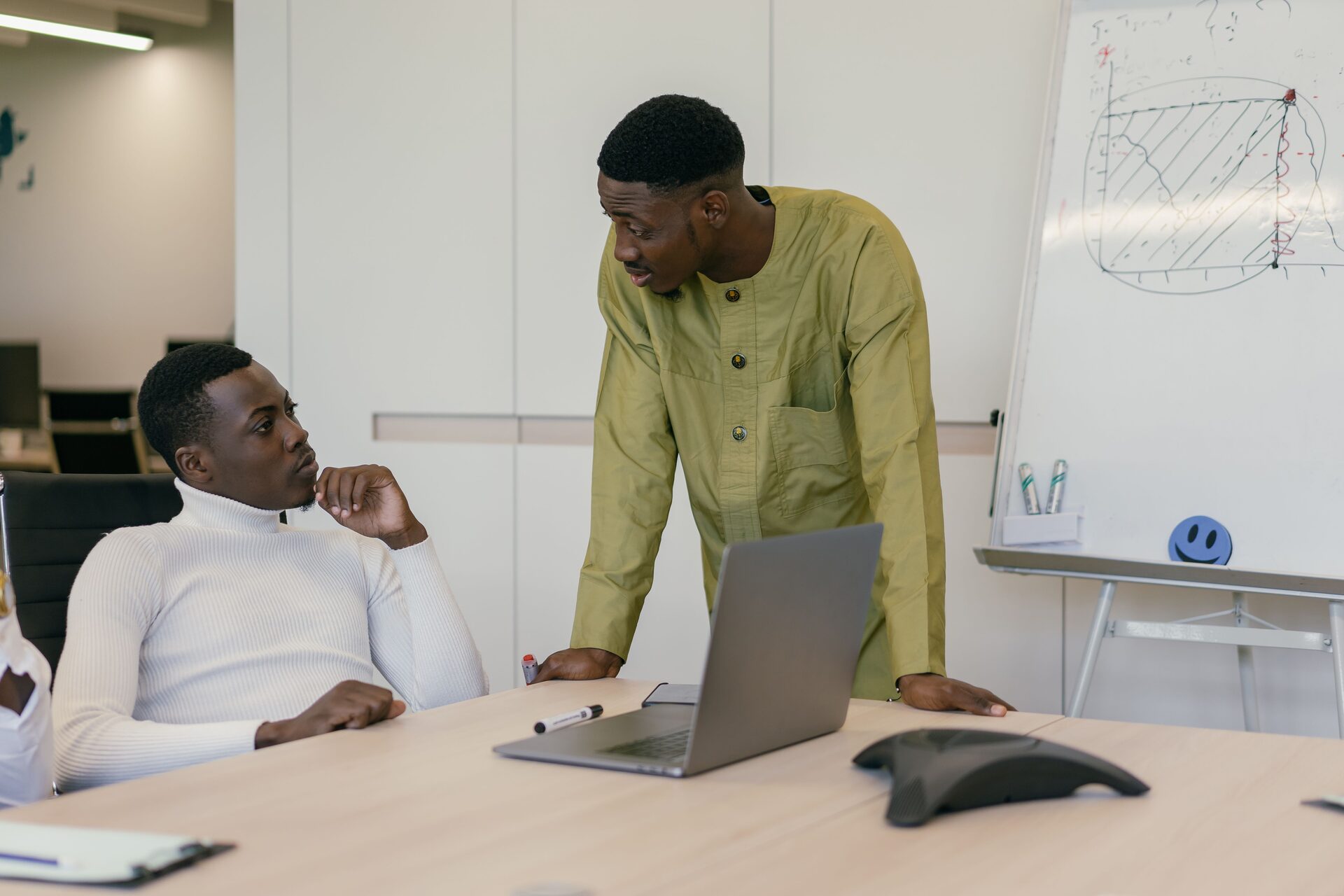 Two colleagues reviewing a wireframe sketch together during a design discussion