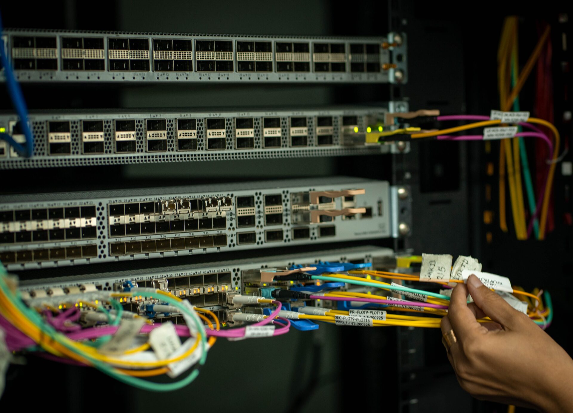 Technician connecting server rack network cabling